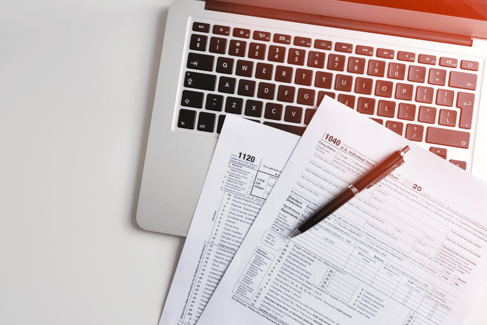 Tax planning in West Monroe, LA by Niswanger Law. Image of IRS tax forms 1040 and 1120 on a laptop with a pen, reflecting the firm’s commitment to accurate, secure filing for business and individual clients.