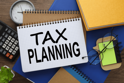 tax planning tips, law firm in West Monroe, LA at Niswanger Law. Image of a notebook labeled “Tax Planning” surrounded by a calculator, clock, and office supplies.
